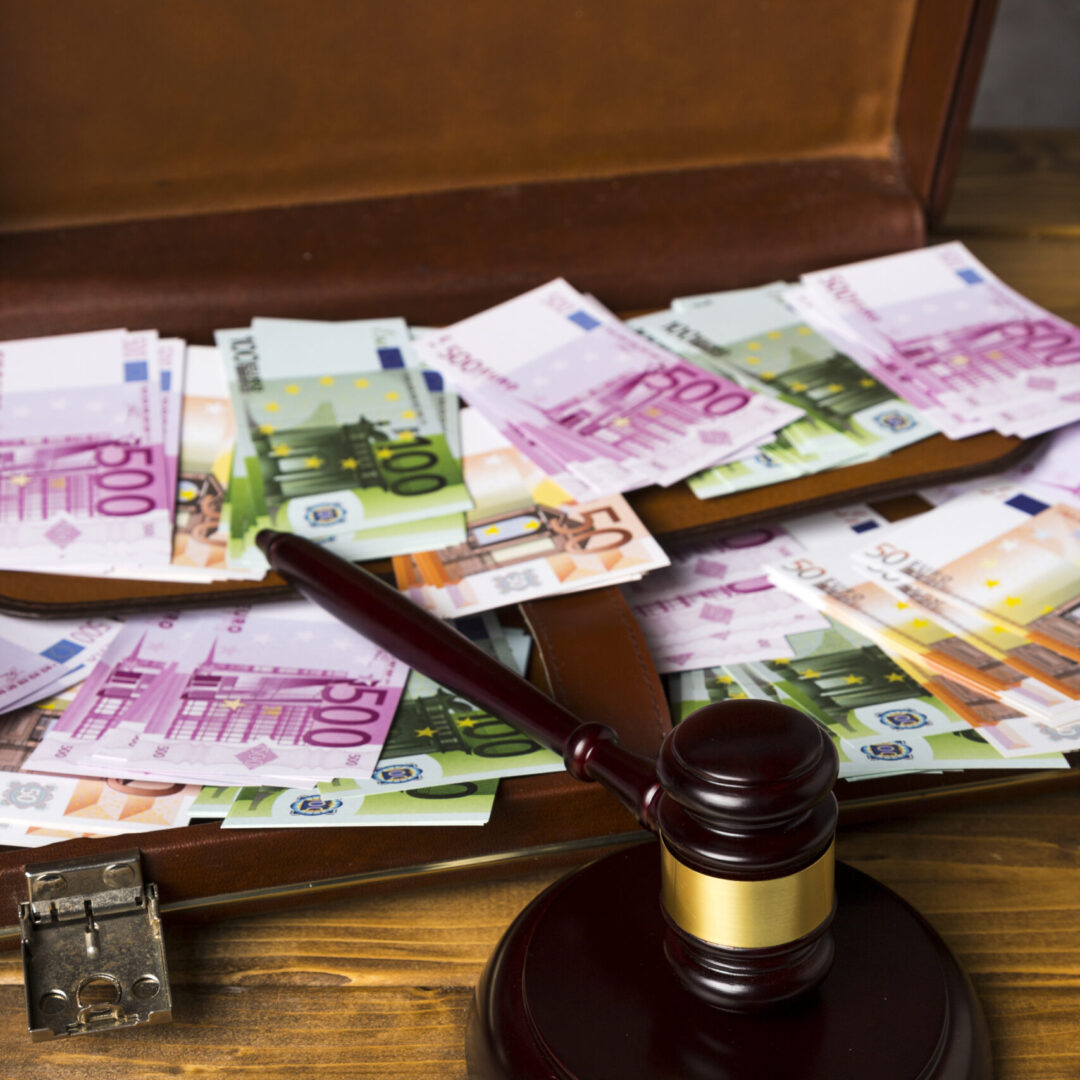 close-up-suitcase-with-money-judge-gavel